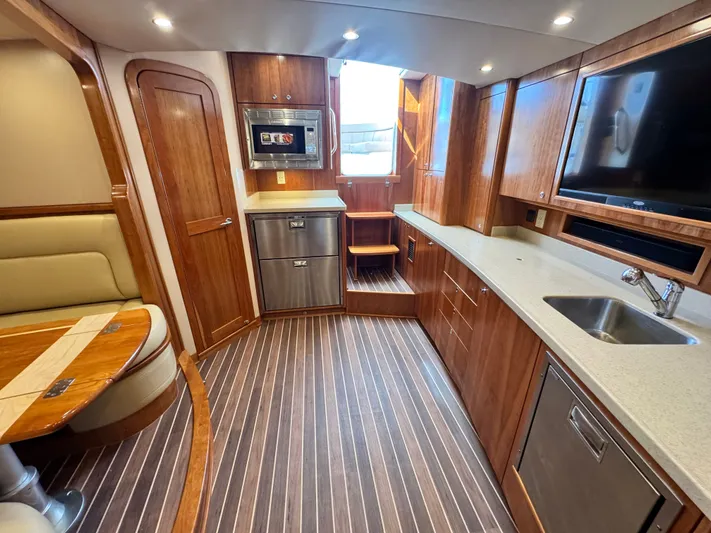 Wendy Ann Yacht Photos Pics Luxurious interior of 2021 Albemarle 41 Express yacht with modern kitchen and seating area.