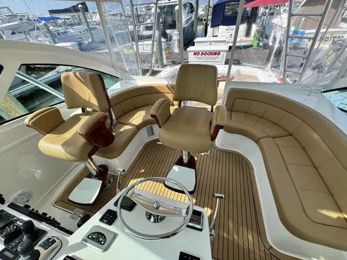 Wendy Ann Yacht Photos Pics Luxurious interior of 2021 Albemarle 41 Express yacht with tan leather seating and modern controls.