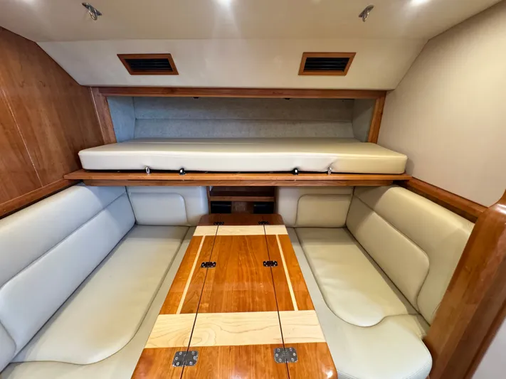 Wendy Ann Yacht Photos Pics 2021 Albemarle 41 Express cabin interior with beige seating and wooden table.