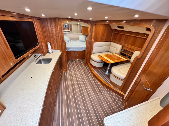 Wendy Ann Yacht Photos Pics Luxurious interior of 2021 Albemarle 41 Express yacht with wood finish and cozy seating area.