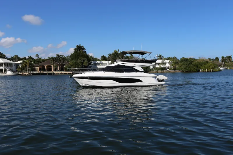 Ytf 002 Yacht Photos Pics 2024 Princess F45 yacht cruising on a serene waterway under a clear blue sky.
