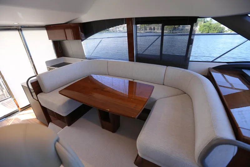 Ytf 002 Yacht Photos Pics Luxurious interior of 2024 Princess F45 yacht with elegant seating and wooden table.