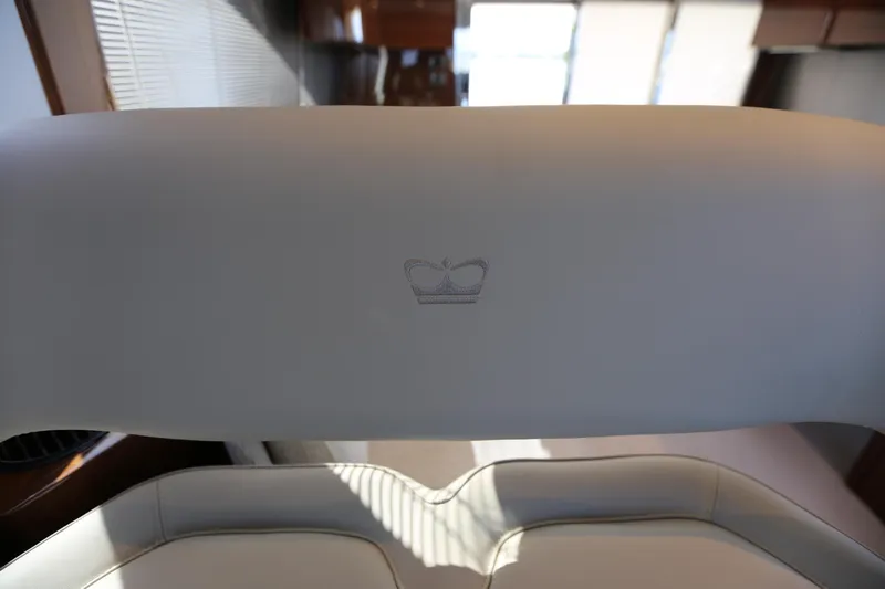 Ytf 002 Yacht Photos Pics 2024 Princess F45 yacht interior with elegant white seating and crown logo detail.