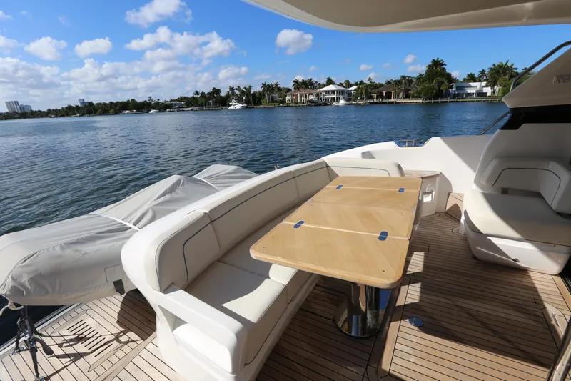 Ytf 002 Yacht Photos Pics 2024 Princess F45 yacht deck with seating and table, overlooking serene water and blue sky.