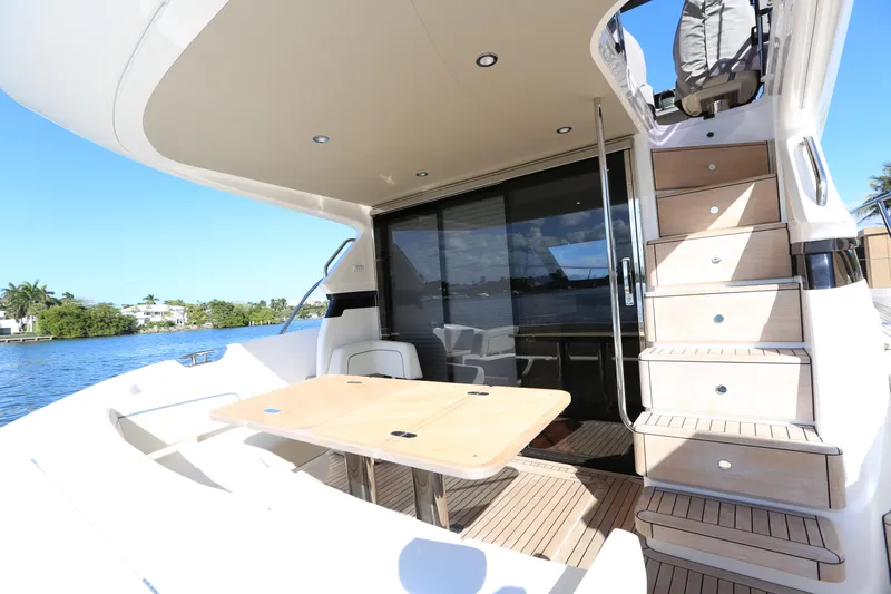 Ytf 002 Yacht Photos Pics 2024 Princess F45 yacht deck with seating and stairs, overlooking serene water.