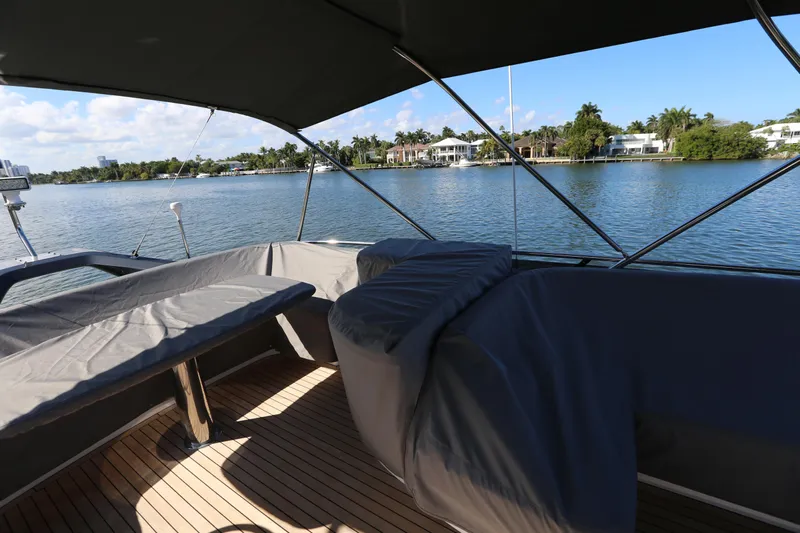 Ytf 002 Yacht Photos Pics 2024 Princess F45 yacht deck with covered seating, overlooking serene waterfront view.