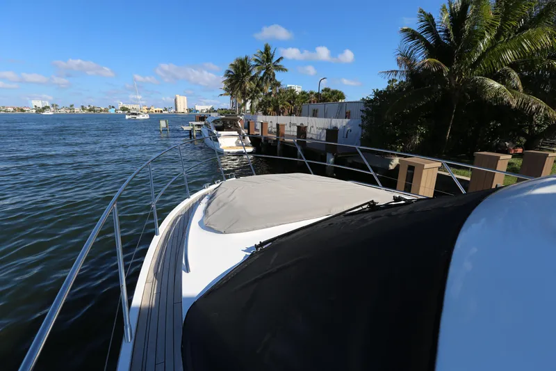 Ytf 002 Yacht Photos Pics 2024 Princess F45 yacht docked by palm trees and waterfront homes.