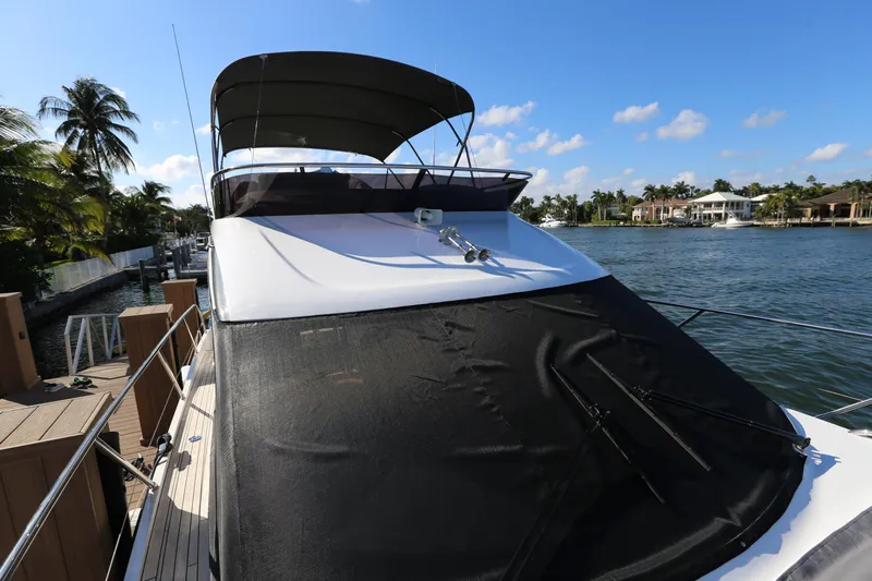 Ytf 002 Yacht Photos Pics 2024 Princess F45 yacht docked by a scenic waterfront with palm trees.