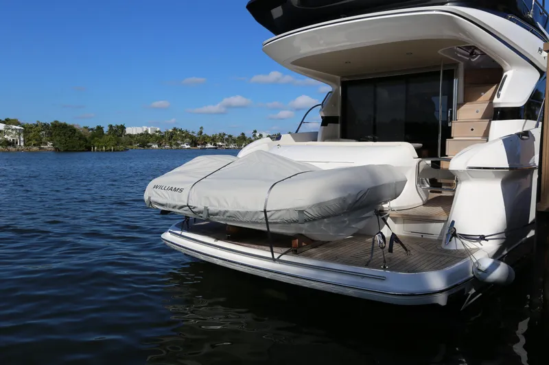 Ytf 002 Yacht Photos Pics 2024 Princess F45 yacht with covered tender on water, showcasing luxury design.