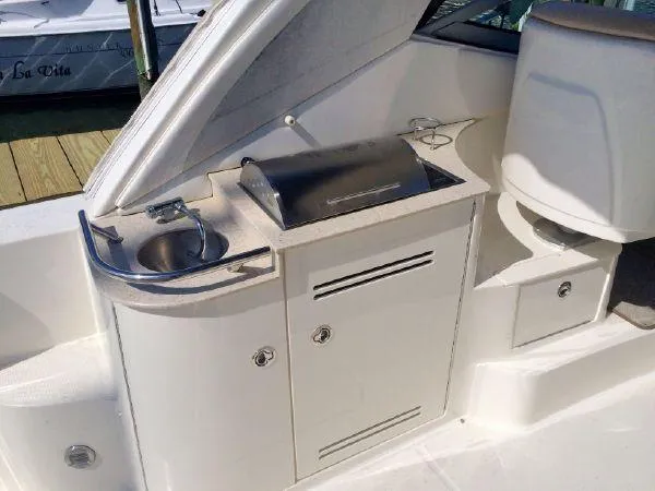 Blue Aye Yacht Photos Pics Outdoor kitchenette on a 2008 Sea Ray 330 Sundancer boat with sink and grill.