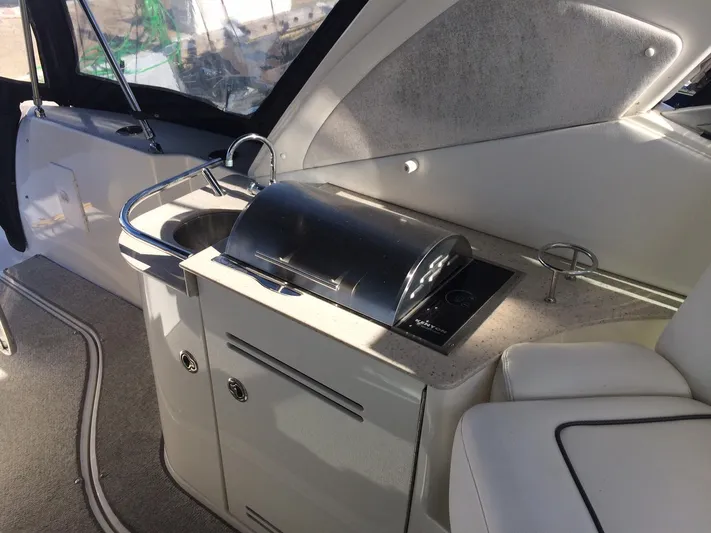 Blue Aye Yacht Photos Pics 2008 Sea Ray 330 Sundancer boat interior with kitchenette and sink.