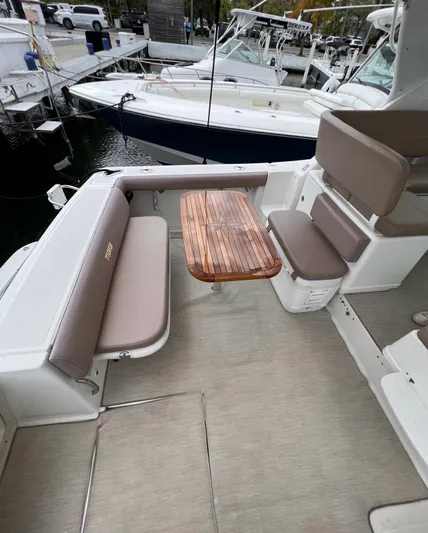  Yacht Photos Pics 2005 Tiara Yachts 3200 Open cockpit with seating and wooden table.