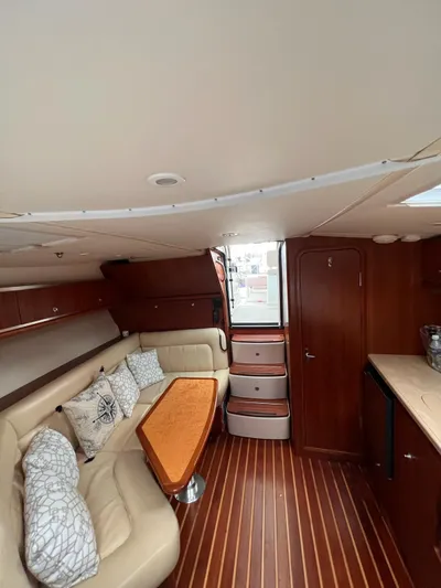  Yacht Photos Pics 2005 Tiara Yachts 3200 Open interior with wood flooring and beige seating.