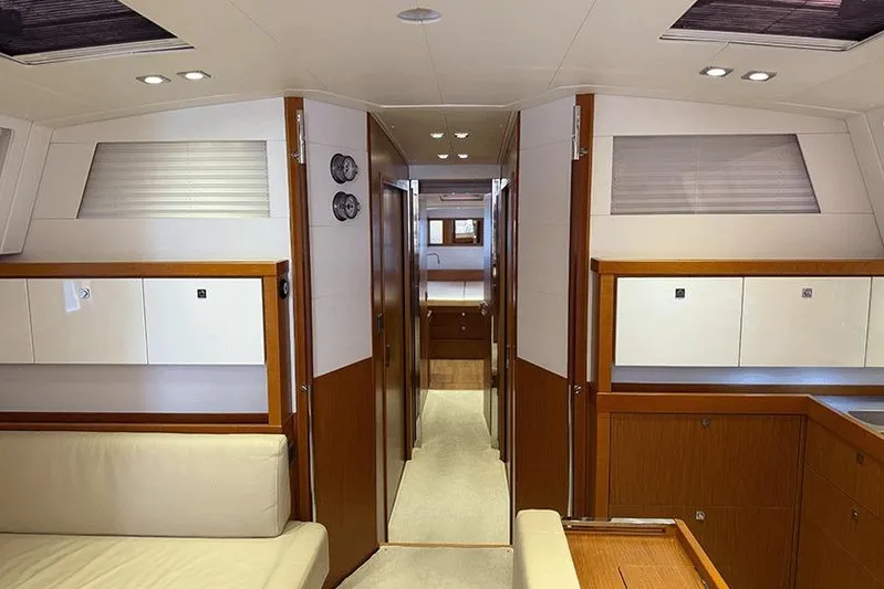 Yacht Photos Pics Interior of 2013 Beneteau Sense 55 yacht, featuring modern wood and white paneling.