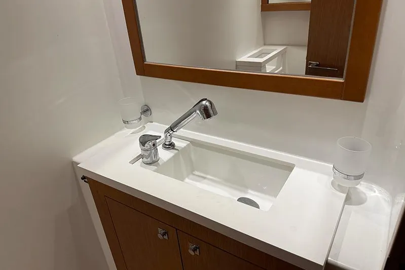  Yacht Photos Pics Modern bathroom sink in 2013 Beneteau Sense 55 yacht, featuring sleek design and wooden accents.