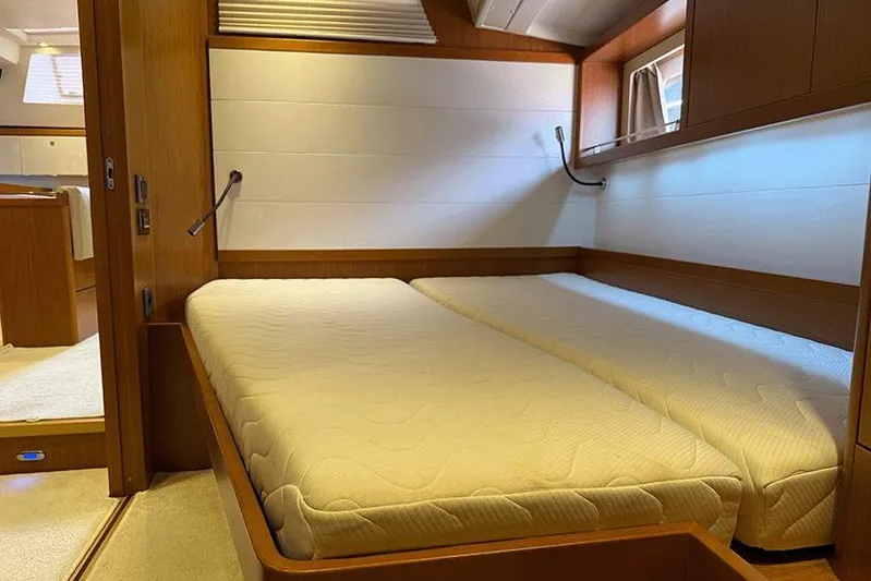  Yacht Photos Pics Interior cabin of 2013 Beneteau Sense 55 yacht with twin beds and wooden finish.
