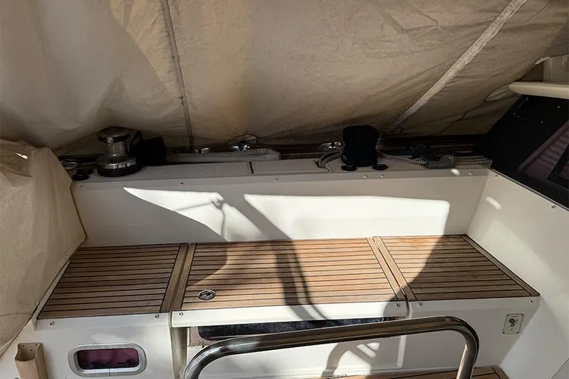  Yacht Photos Pics Interior view of 2013 Beneteau Sense 55 sailboat with wooden seating and winch.