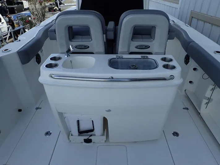  Yacht Photos Pics 2023 Boston Whaler 280 Outrage boat interior with seating and fishing station.