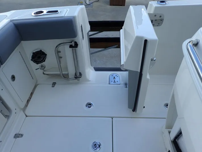  Yacht Photos Pics 2023 Boston Whaler 280 Outrage deck with seating and storage compartments.