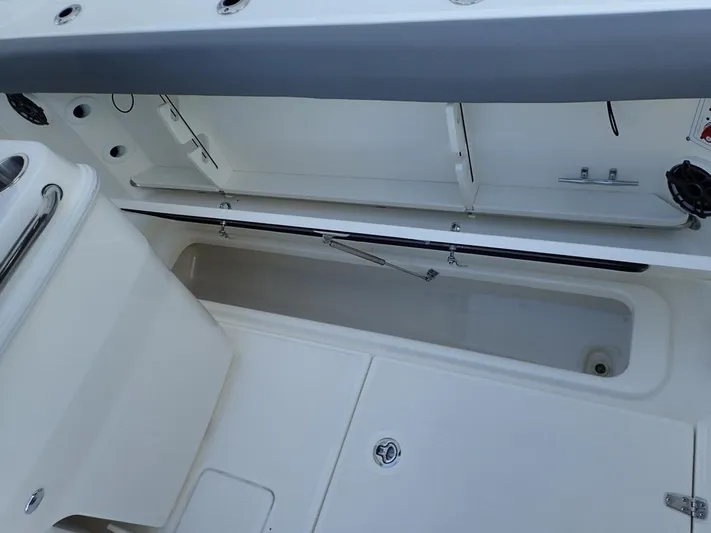  Yacht Photos Pics 2023 Boston Whaler 280 Outrage interior storage compartment, open and spacious design.
