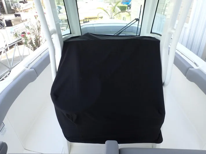 Yacht Photos Pics 2023 Boston Whaler 280 Outrage console with protective cover, showcasing sleek interior design.