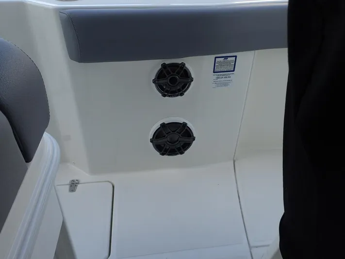  Yacht Photos Pics 2023 Boston Whaler 280 Outrage boat interior with dual speakers and seating area.