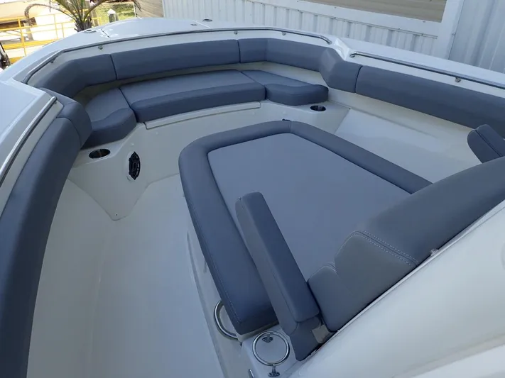  Yacht Photos Pics 2023 Boston Whaler 280 Outrage boat interior with gray cushioned seating.