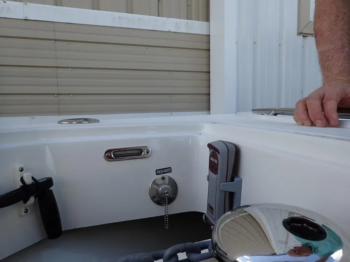  Yacht Photos Pics 2023 Boston Whaler 280 Outrage boat interior detail with hand and equipment.