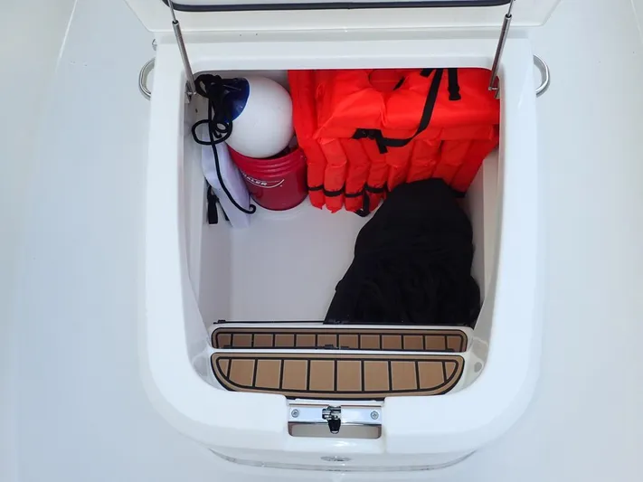  Yacht Photos Pics Storage compartment on 2023 Boston Whaler 280 Outrage with life jackets and boating gear.