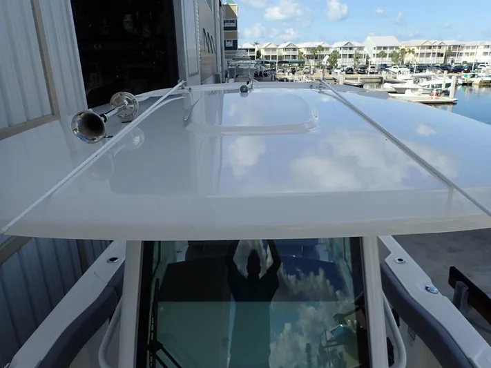  Yacht Photos Pics 2023 Boston Whaler 280 Outrage boat roof with marina view in background.