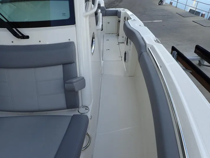  Yacht Photos Pics 2023 Boston Whaler 280 Outrage boat interior with gray seating and sleek design.
