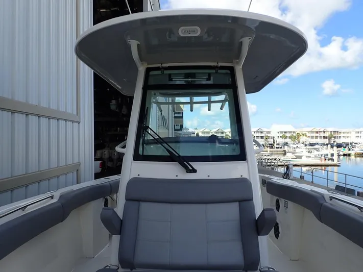  Yacht Photos Pics 2023 Boston Whaler 280 Outrage boat docked, featuring a spacious seating area and modern design.