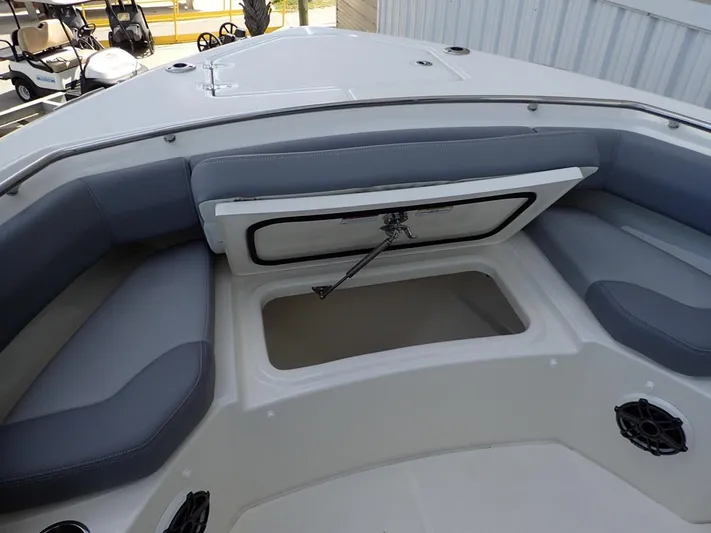  Yacht Photos Pics 2023 Boston Whaler 280 Outrage boat interior with open storage compartment and cushioned seating.