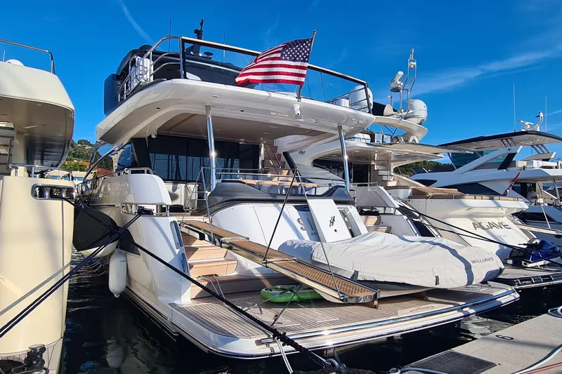 Yacht Photos Pics Luxurious 2022 Princess Y85 yacht docked, featuring sleek design and American flag.
