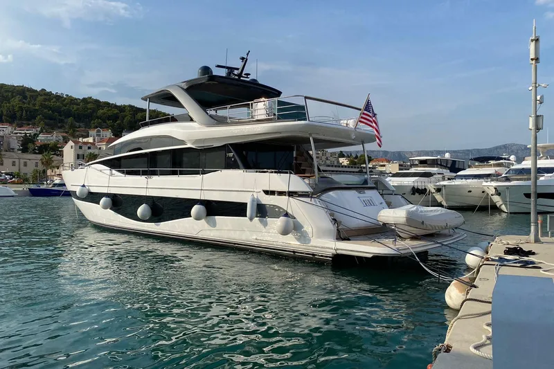  Yacht Photos Pics Luxury 2022 Princess Y85 yacht docked in a scenic marina.
