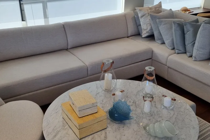  Yacht Photos Pics Luxurious Princess Y85 yacht interior with elegant beige sofa and marble table, 2022 model.