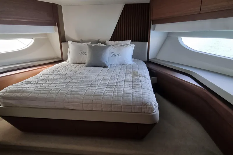  Yacht Photos Pics Luxurious bedroom interior of 2022 Princess Y85 yacht with elegant bedding and large windows.
