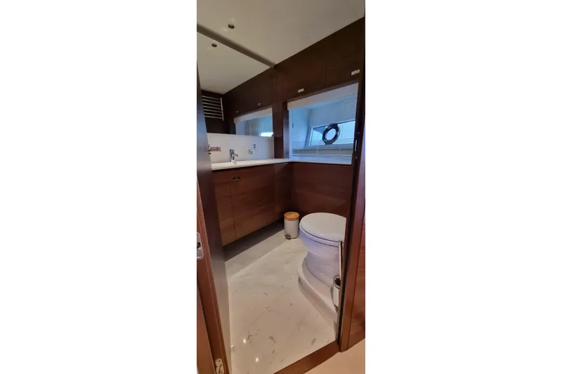  Yacht Photos Pics Luxurious bathroom on 2022 Princess Y85 yacht with modern fixtures and wooden cabinetry.