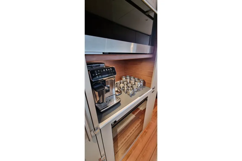  Yacht Photos Pics Modern kitchen with espresso machine and cups on a Princess Y85 yacht, 2022 model.