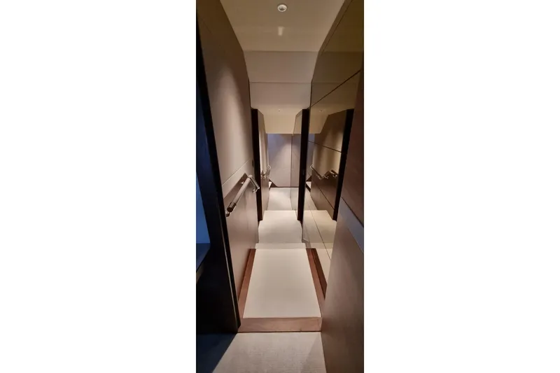 Yacht Photos Pics Narrow hallway inside 2022 Princess Y85 yacht, featuring sleek modern design and lighting.