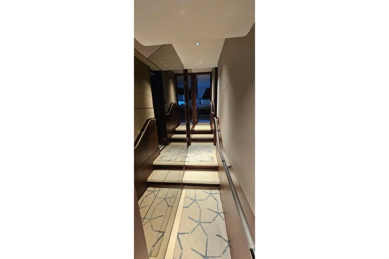  Yacht Photos Pics Luxurious interior hallway of 2022 Princess Y85 yacht with elegant carpeted stairs.