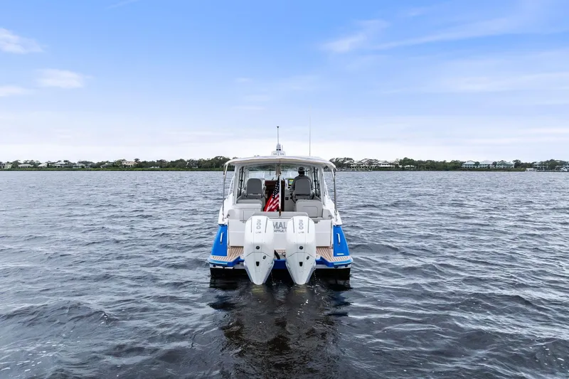 Tumalum Yacht Photos Pics 2023 MJM 35 boat on open water, rear view with twin engines.
