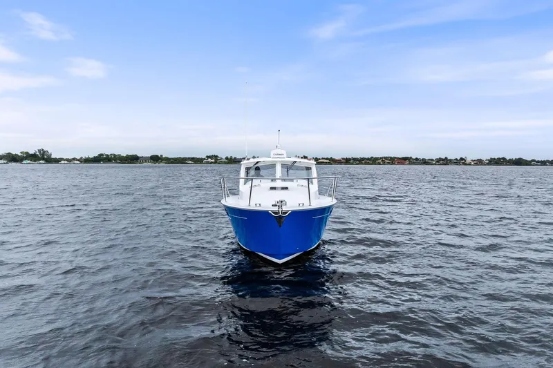 Tumalum Yacht Photos Pics 2023 MJM 35 boat on open water under a clear blue sky.