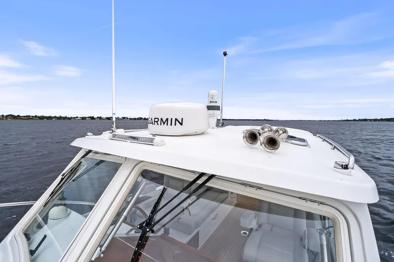 Tumalum Yacht Photos Pics 2023 MJM 35 boat with Garmin radar on calm water under blue sky.