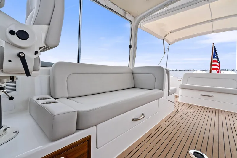 Tumalum Yacht Photos Pics 2023 MJM 35 boat interior with sleek seating and American flag.