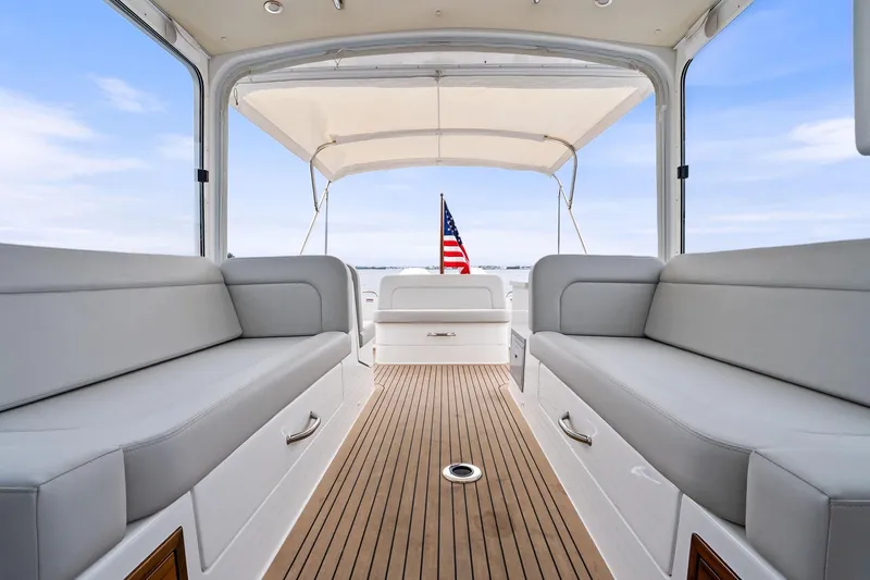 Tumalum Yacht Photos Pics 2023 MJM 35 boat interior with cushioned seating and American flag.