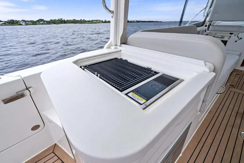 Tumalum Yacht Photos Pics Luxury MJM 35 yacht deck with built-in grill, 2023 model, overlooking serene waters.