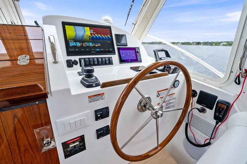 Tumalum Yacht Photos Pics Helm of 2023 MJM 35 boat with advanced navigation displays and wooden steering wheel.