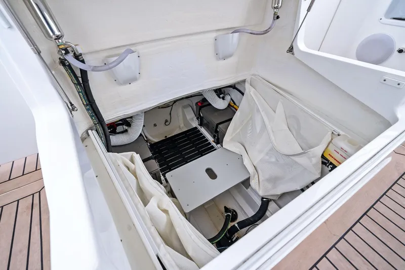 Tumalum Yacht Photos Pics 2023 MJM 35 boat storage compartment with organized equipment and white interior.