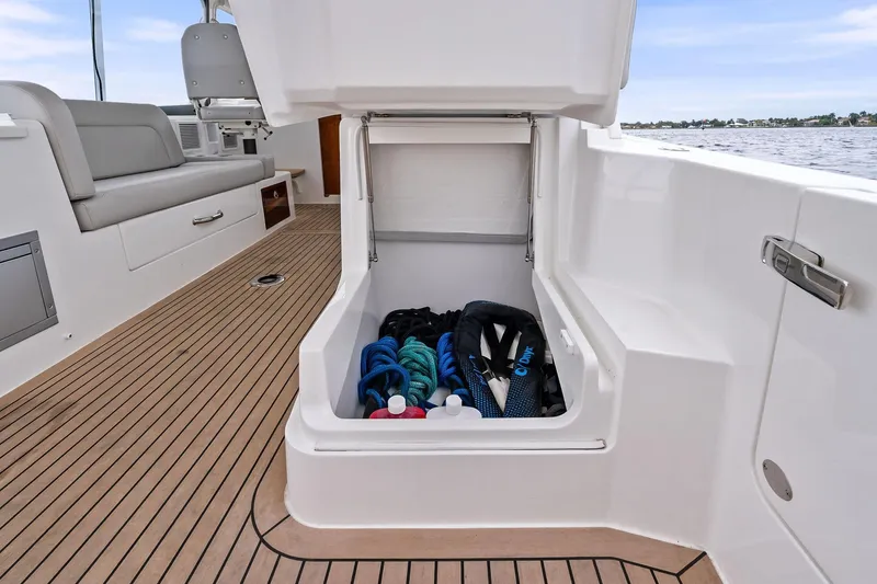 Tumalum Yacht Photos Pics 2023 MJM 35 boat storage compartment with ropes and gear on deck.